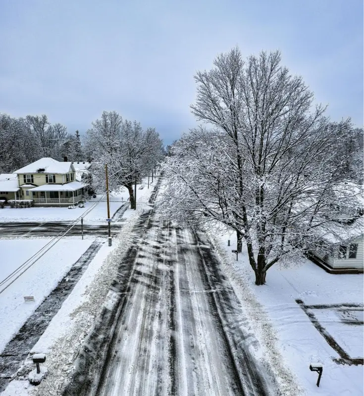 Residential New England street showing winter site conditions